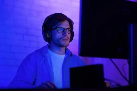 Man Working On Computer Programming Website Sitting Indoor At Night Stock Photos