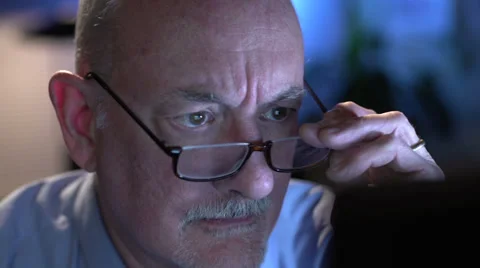 Man working on computer, puts on glasses 動画素材 36040349