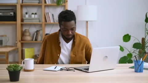 Man working with computer remotely and sitting at desk in home office spbas. Stock Footage 149824082