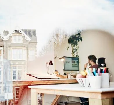 A man working at a computer screen in a design studio Stockfoto's
