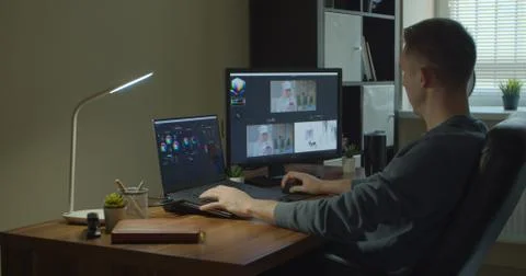 Man working on computer with Two Monitors Color Correction Post Production video Foto stock