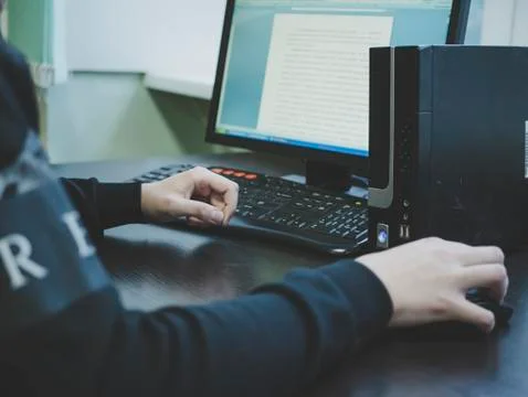 Man working on computer typing on the keyboard. Stock Photos