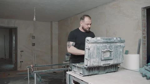 Man working in a construction area with tools and unfinished walls Stock Footage 307041110