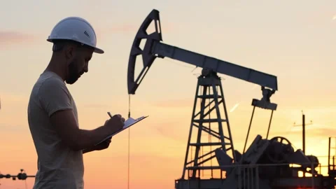 Man in a working construction helmet makes notes in the report. Video stock 240735655