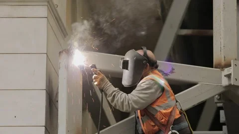 Man working in construction site welding the irons Stock Footage 147843974