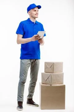 Man working in delivery has three parcels by his side. Stock Photos
