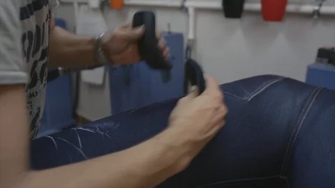 Man working on denim jeans in workshop Stock Footage 114711168
