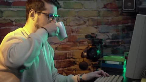 Man Working on Desktop Computer From 1990s. Typing and Drinking Coffee at Night Stock Footage 301882808