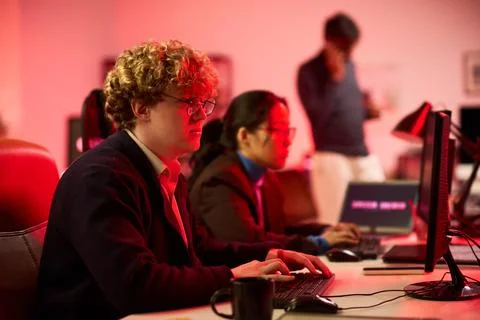 Man Working on Desktop Computer in Modern Cybersecurity Office Stock Photos