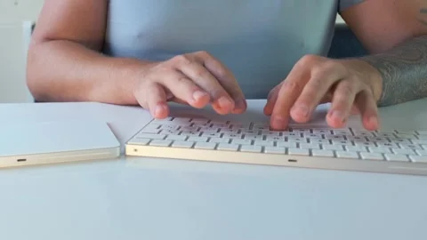 Man working on desktop computer typing on keyboard with hands close up. Everyday Stock Footage 333768718