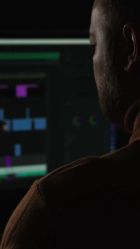 Man working on a digital editing project in a dark studio environment during Stock Footage 322144964