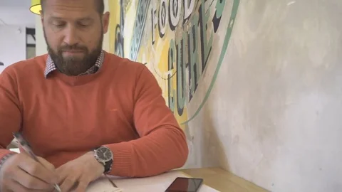 Man working with documents, files, writing, portrait, in cafe, steadicam Vídeo Stock 73265601