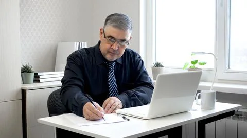 Man Working with Documents at Office Desk Stock Photos