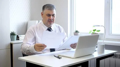 Man Working with Documents at Office Desk 스톡 사진