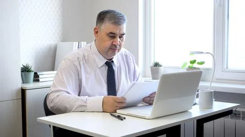 Man Working with Documents at Office Desk Stock Photos