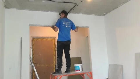 Man working on door frame in home renovation project in living room during dayti Stock Footage 329825909