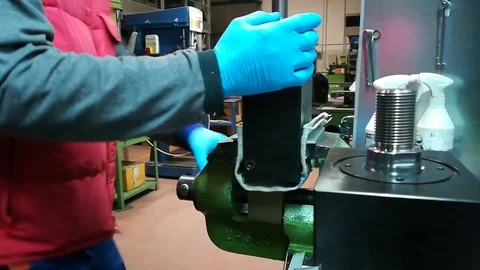 A man working at Drill press and bank clasp in a factory Stock Footage 83216037