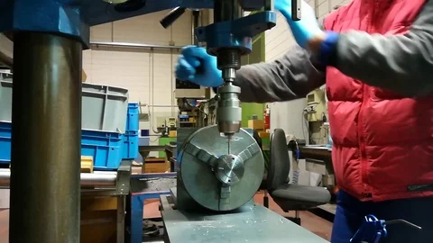 A man working at Drill press and bank clasp in a factory Stock Footage 83216625