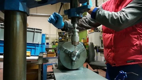 A man working at Drill press and bank clasp in a factory Stock Footage 83217013