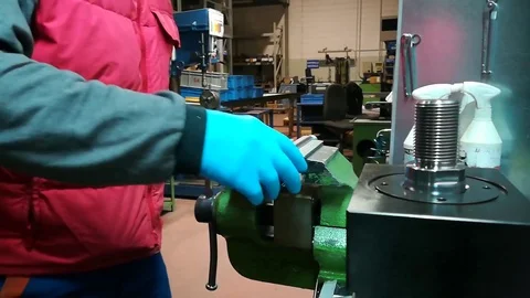 A man working at Drill press and bank clasp in a factory Stock Footage 83222894
