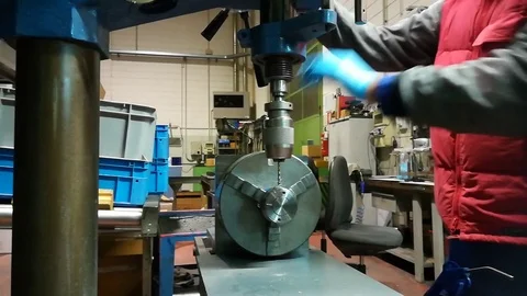A man working at Drill press and bank clasp in a factory Stock Footage 83223135