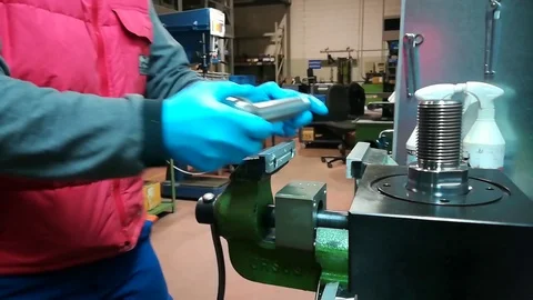 A man working at Drill press and bank clasp in a factory Stock Footage 83223619