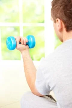 Man working with dumbbells Stock Photos