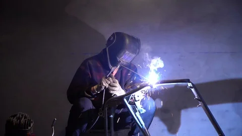 Man working electric welding.Working in garage Stock Footage 124360731