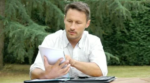 Man working with electronic tablet at home Stock Footage 14831850