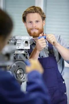 Man working on an engine Stock Photos