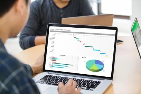 Man working with excel project dashboard on laptop at the office Stock Photos