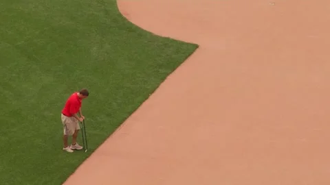 Man working fake grass in a baseball stadium Stock Footage 159908749