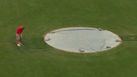 Man working the fake grass of a baseball stadium Stock Footage 159908758
