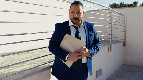 Man Working In Finance Reading A Document In The Open Air Stock Footage 310689400