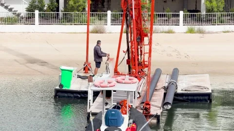 Man Working on a Floating Dock with Red Crane in Gold Coast Canal Stock Footage 334282735