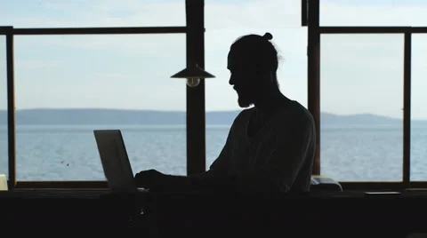 Man working in front of the sea during vacation time Stock Footage 68056751