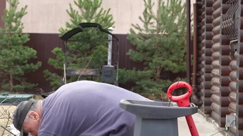 Man working in the garden, chopping branches with a garden shredder Stock Footage 272139818