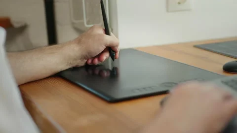 Man working with a graphics tablet, close-up of hands. Worker drawing with a Stock Footage 200900396
