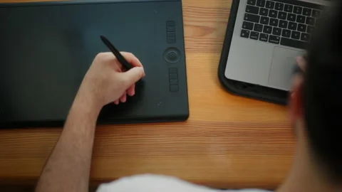 Man working with a graphics tablet. Web designer creates sketches on a graphics Video stock 200872891