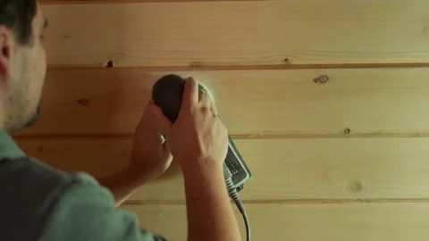 A man working with a grinding machine at the construction site. Male carpenter Stock-Footage 162447351
