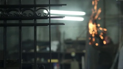 A man is working with a grinding machine at an industrial factory Stock Footage 72069297