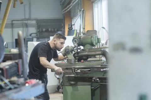 Man working in grinding workshop Stock Photos