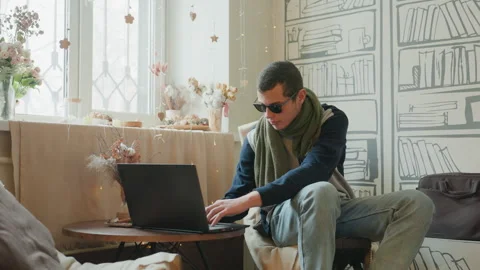 Man working happily. Focused man in cozy workspace. Freelancer engaged in work Stock Footage 338773845