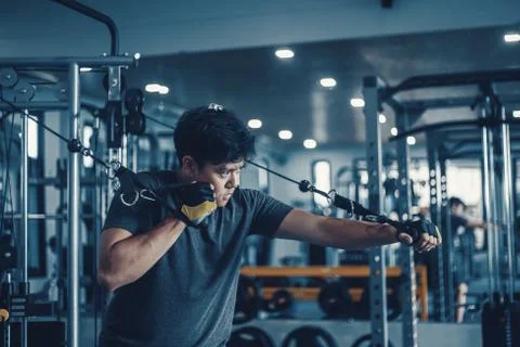 A man working On His Chest With Cable Crossover In Gym. Fitness, workout, spo Stock Photos