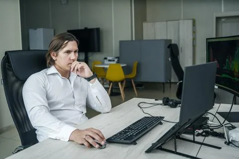 Man working at his computer in a modern office space. Foto stock