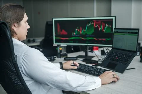 Man working at his computer in a modern office space. Foto stock