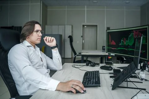Man working at his computer in a modern office space. 写真素材