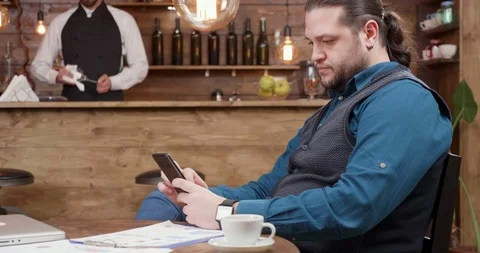 Man working on his computer from a restaurant. Stock Footage 105400277