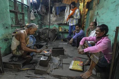 A man working in his forge workshop Stock Photos