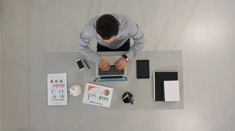 Man working on his laptop typing on computer sitting at table. Top view Stock-Footage 58172471